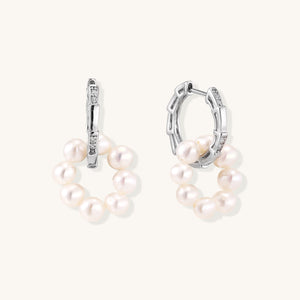 Silver drop earrings with textured bar studs and large round baroque pearls—modern private-label statement jewelry