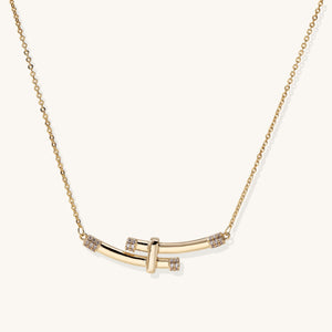 Layered gold necklaces featuring a herringbone chain, coin charms, and crescent moon pendant—boho-chic private-label jewelry
