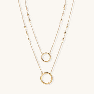 Gold infinity pendant necklace with baguette-cut zircon stones and adjustable chain—elegant private-label jewelry design