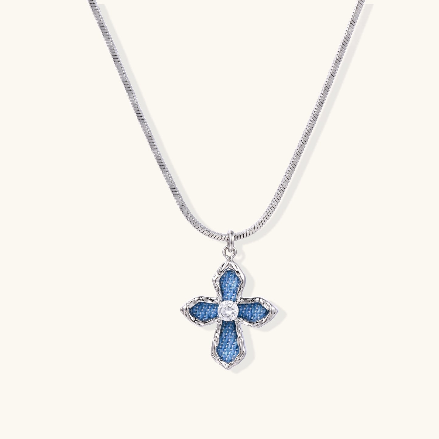 Gold-plated cross pendant with blue denim fabric insets and central zirconia stone on adjustable snake chain