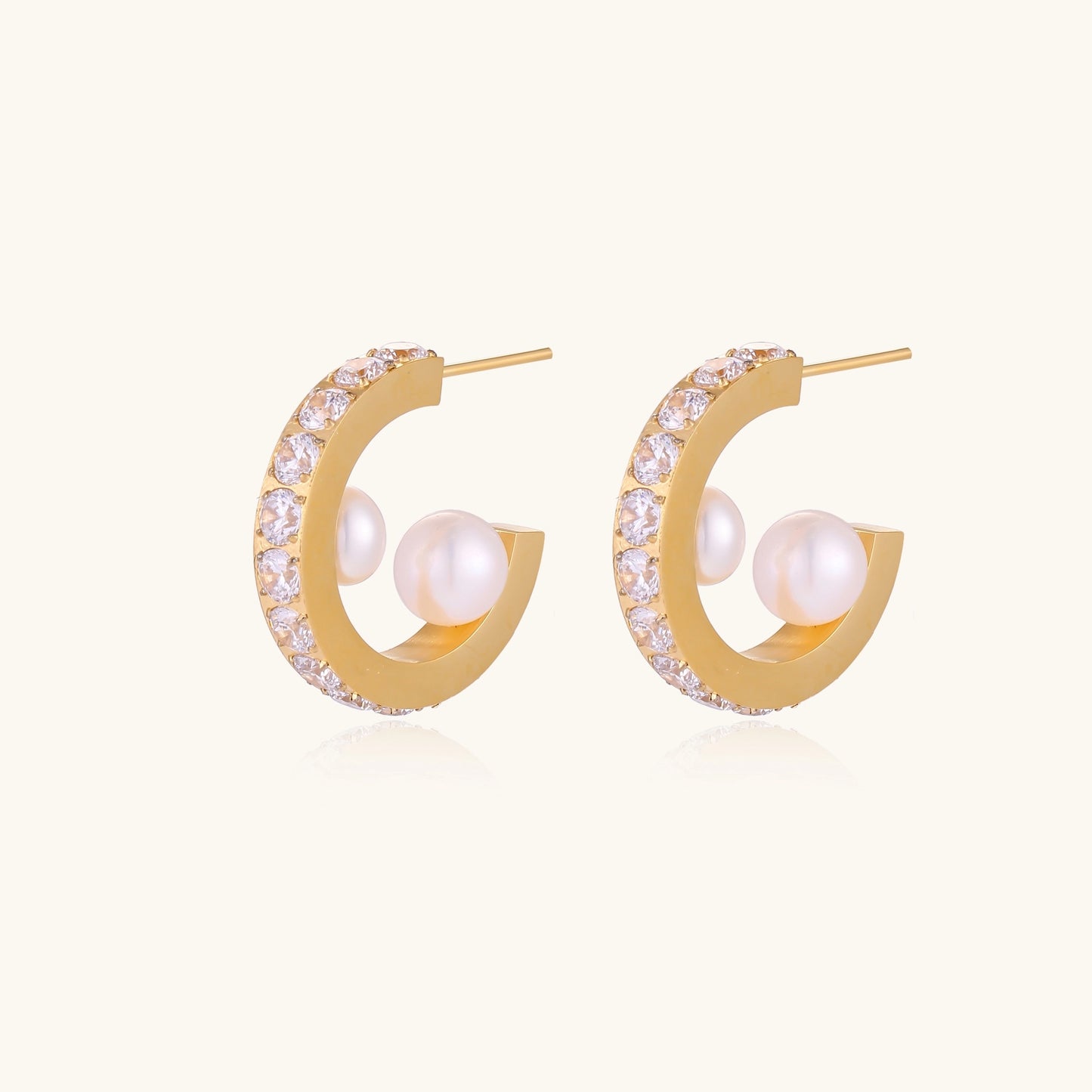 Gold-plated hoop earrings with crystal pavé and floating freshwater pearls inside the circular design.