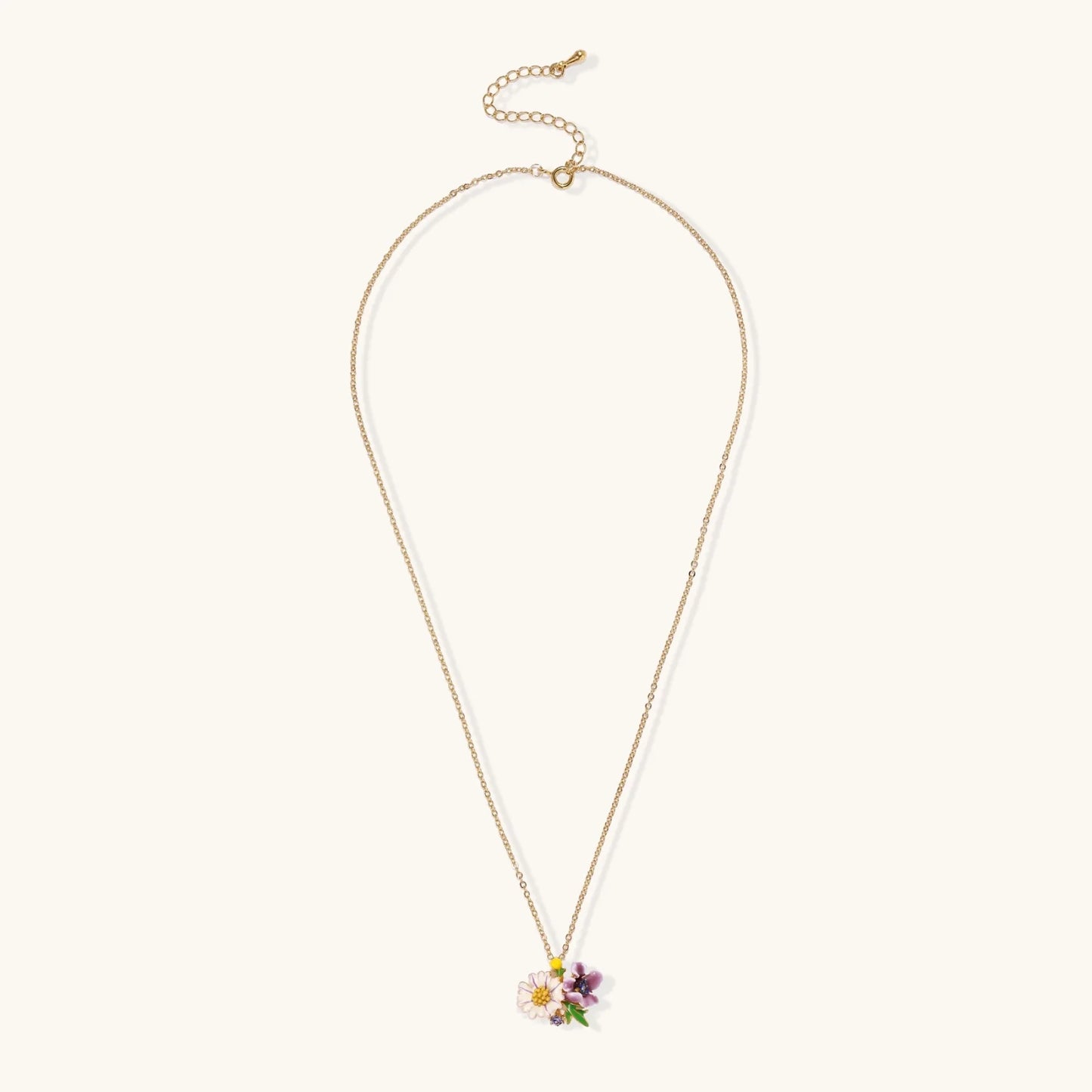 Gold-plated necklace with pink and purple enamel flower pendant featuring crystal accents on cream background