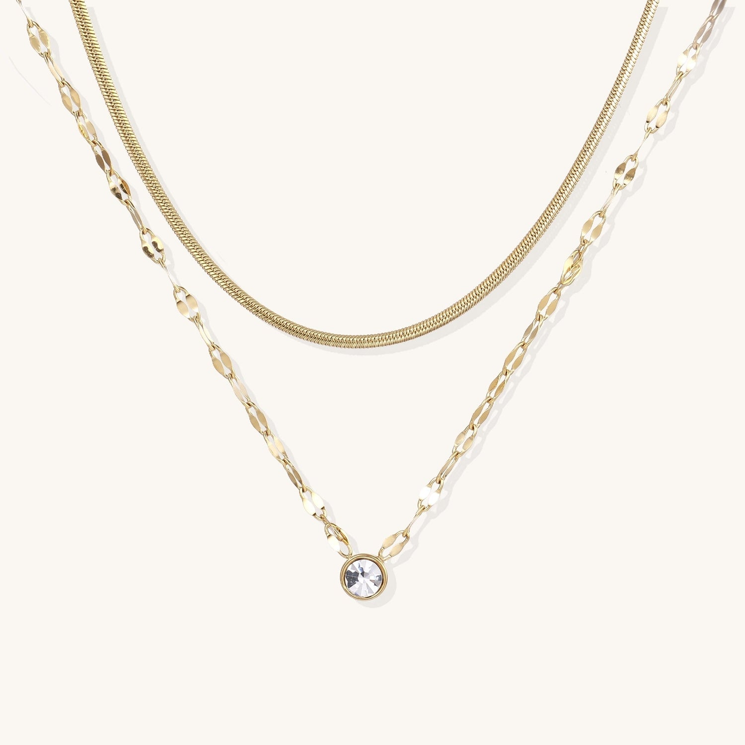 Gold chain necklace with alternating freshwater pearls and baroque pearl charms wrapped in floral filigree—elegant private-label jewelry collection display