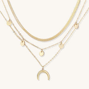 Layered gold necklace with black faceted beads, curb chain, and turquoise evil-eye pendant—boho-inspired private-label jewelry