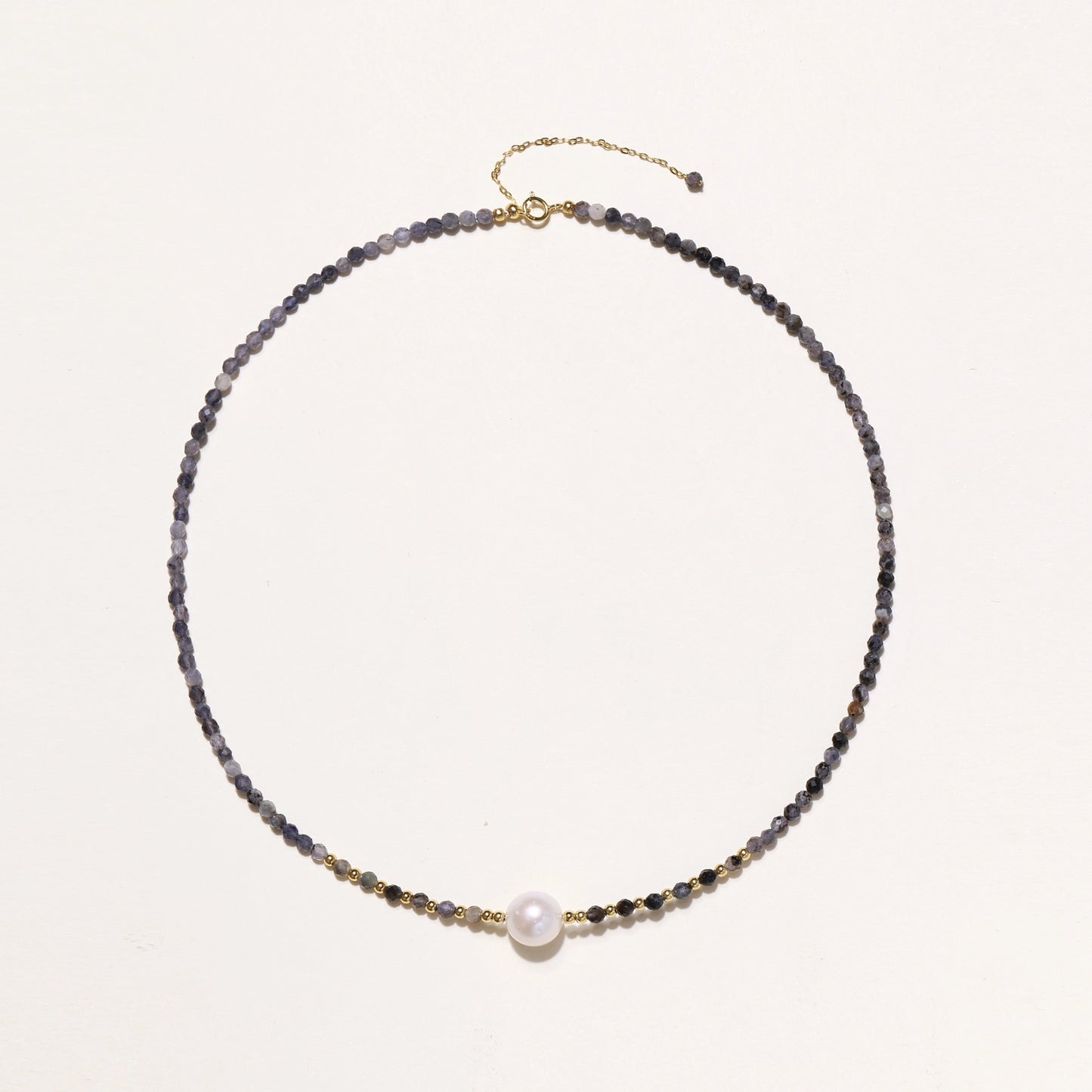 Dainty necklace with faceted purple iolite beads, gold vermeil accents, and central pink-white freshwater pearl.