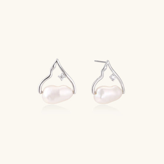 Sterling silver teardrop-shaped stud earrings with white freshwater pearls nestled in elegant flame-like frames