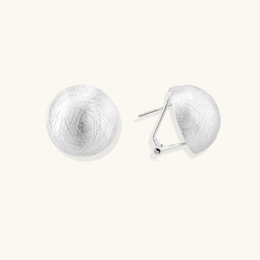 Brushed sterling silver dome-shaped stud earrings with textured surface and secure lever-back closure on white background.