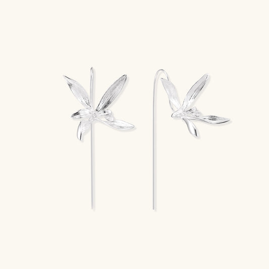Delicate sterling silver flower earrings with long threader posts and five-petal design on white background.