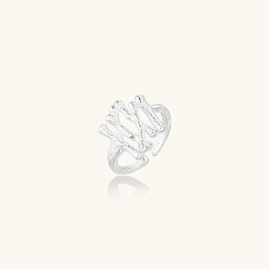 Chunky sterling silver ring with organic sculptural design and flowing abstract forms on white background