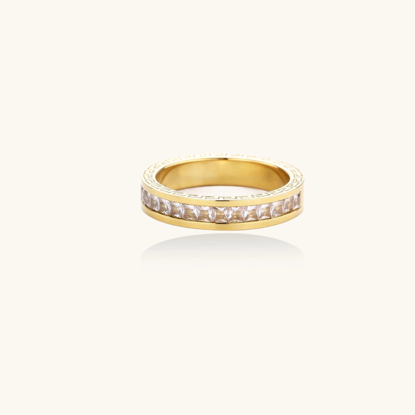 14K gold plated ring with channel-set zirconia stones and Greek key pattern engraved on sides on white background