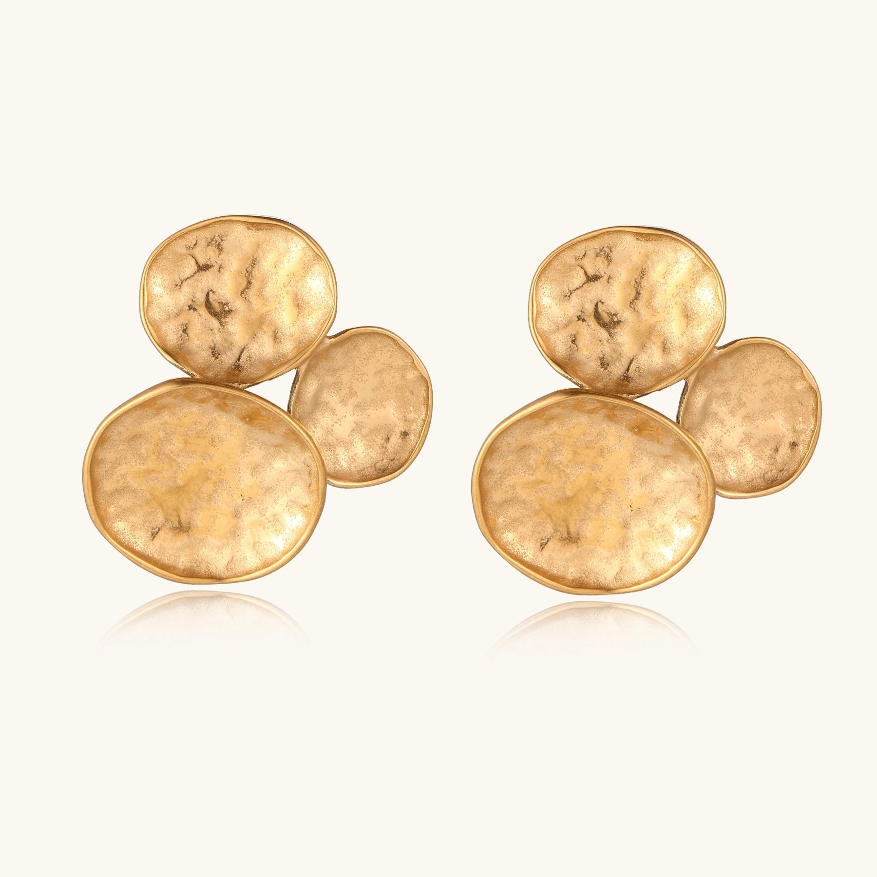 Sculptural gold-plated stainless steel earrings with three hammered oval shapes arranged in artistic cluster formation