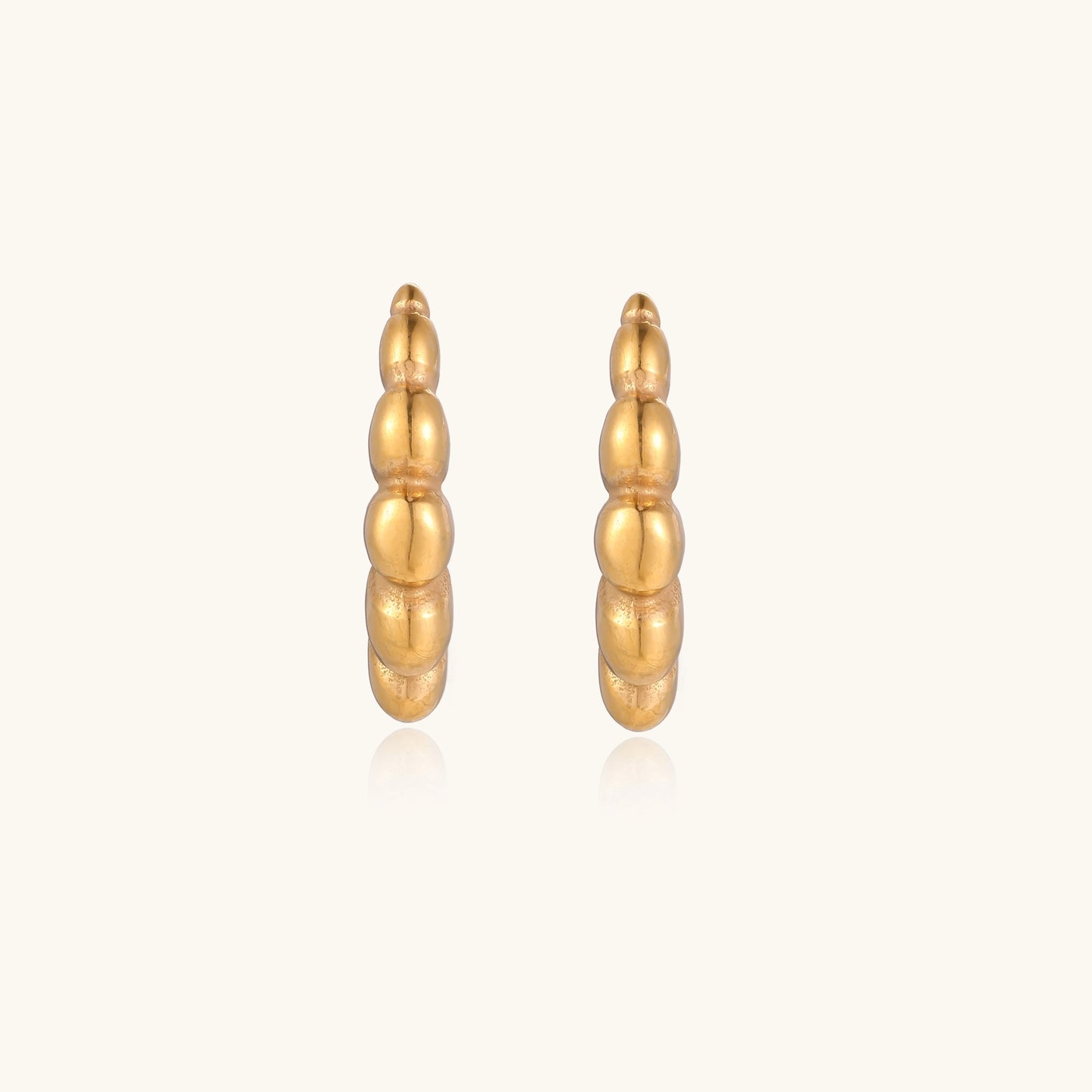 Gold-plated stainless steel hoop earrings with segmented bubble design and post closure on white background