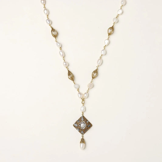 Y-shaped necklace with freshwater pearls, gold filigree stations, and ornate diamond-shaped centerpiece with pearl drop