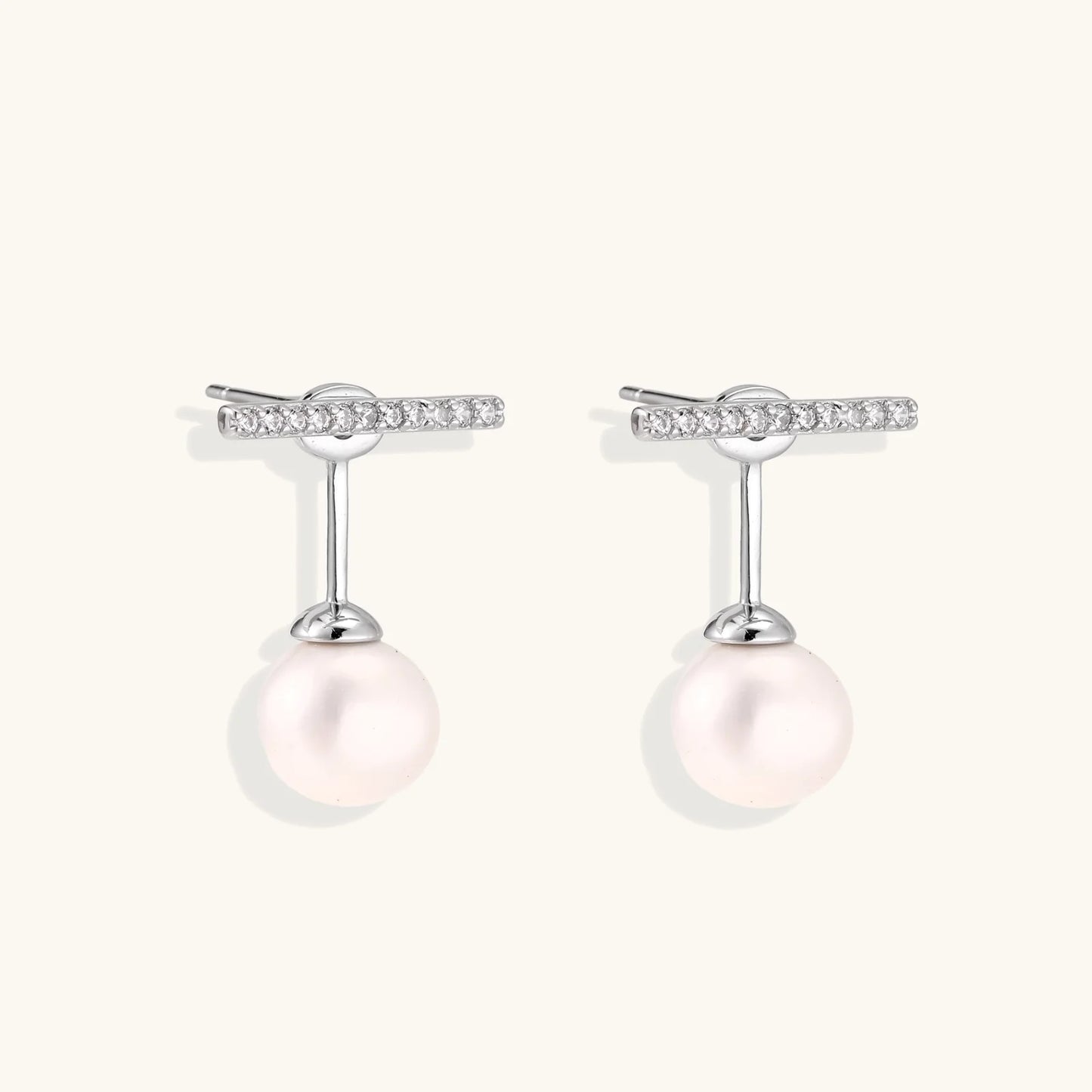 Rhodium-plated sterling silver ear jacket earrings with diamond-set horizontal bar and freshwater pearl drop