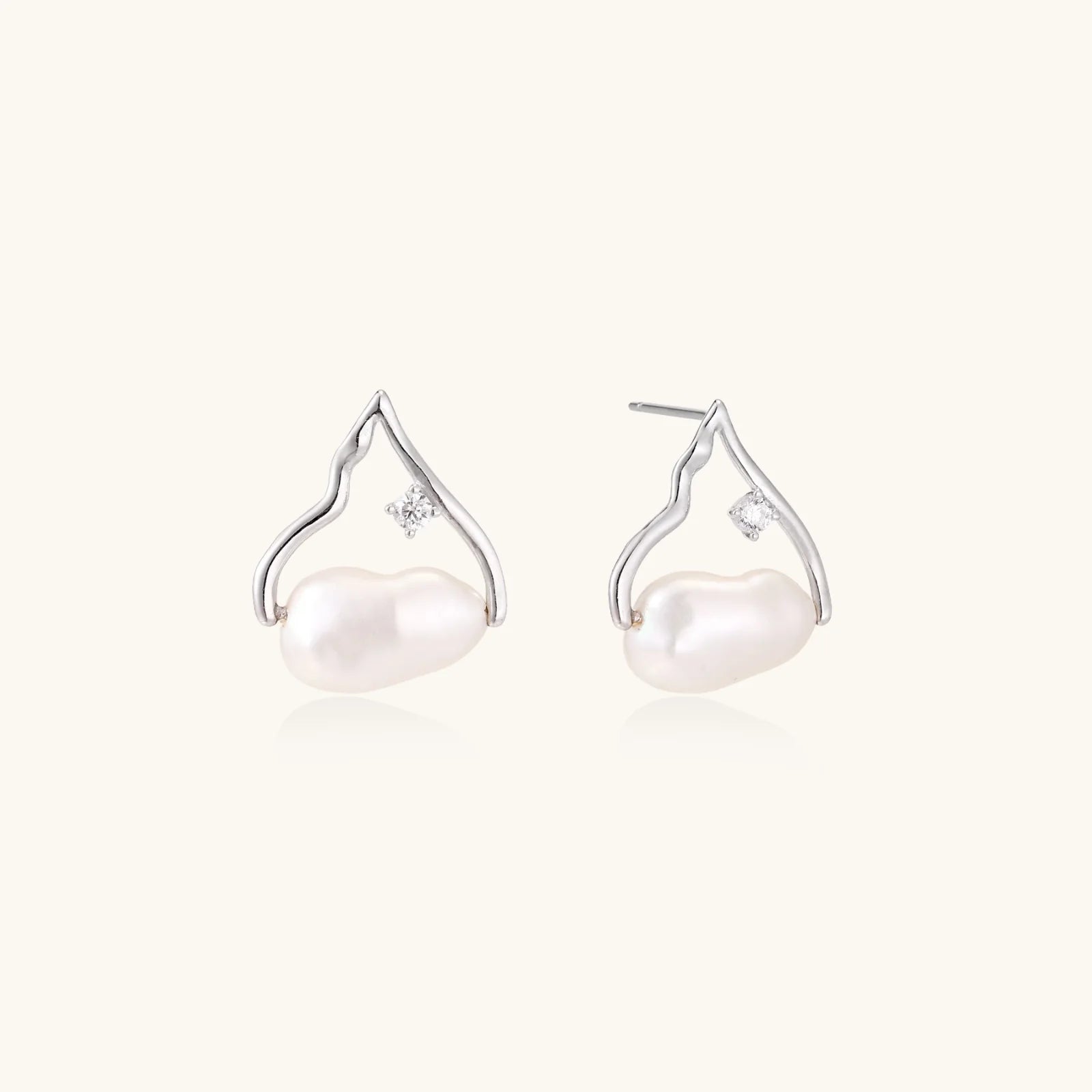 Silver mountain outline studs with baroque pearl and diamond accent on white background