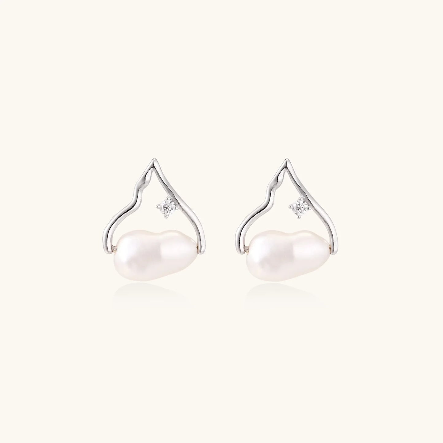 Silver mountain outline studs with baroque pearl and diamond accent on white background