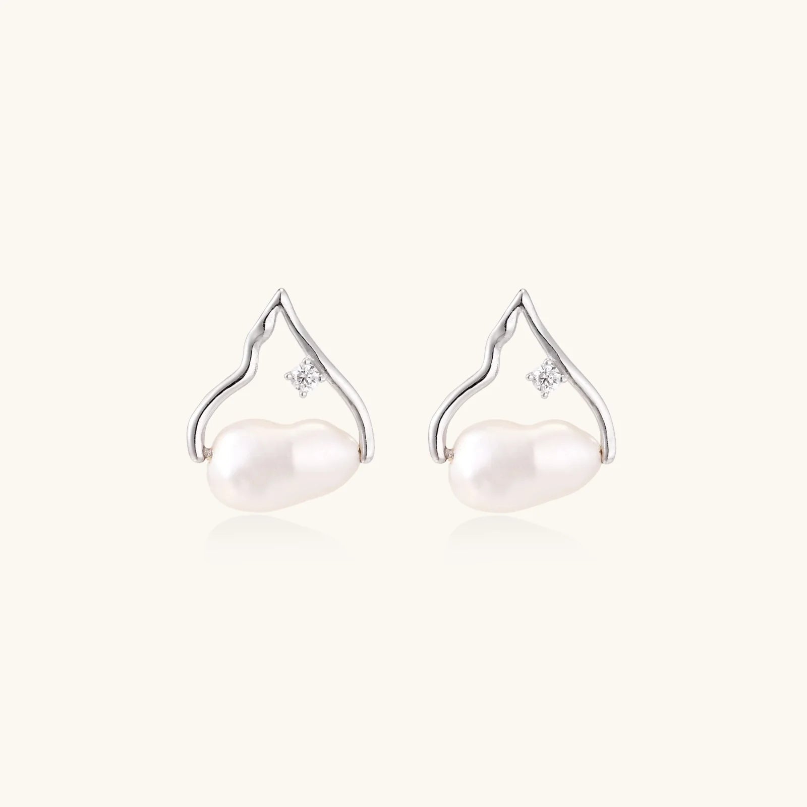 Silver mountain outline studs with baroque pearl and diamond accent on white background