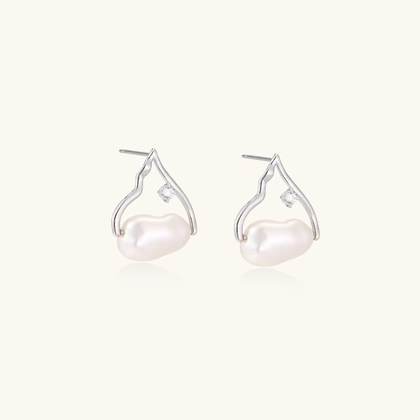 Silver mountain outline studs with baroque pearl and diamond accent on white background