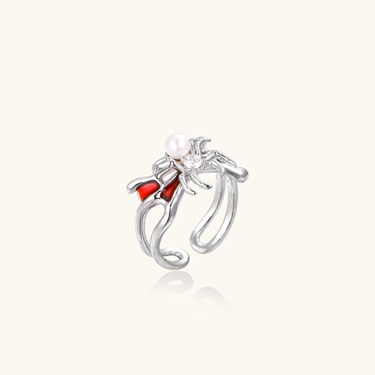 White gold plated spider ring with pearl body, clear zirconia center, and red enamel leg accents on adjustable band