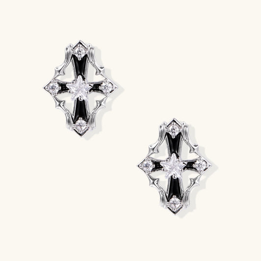 Pair of Art Deco-style stud earrings with star crystals, black enamel accents, and white gold plating on ivory background.