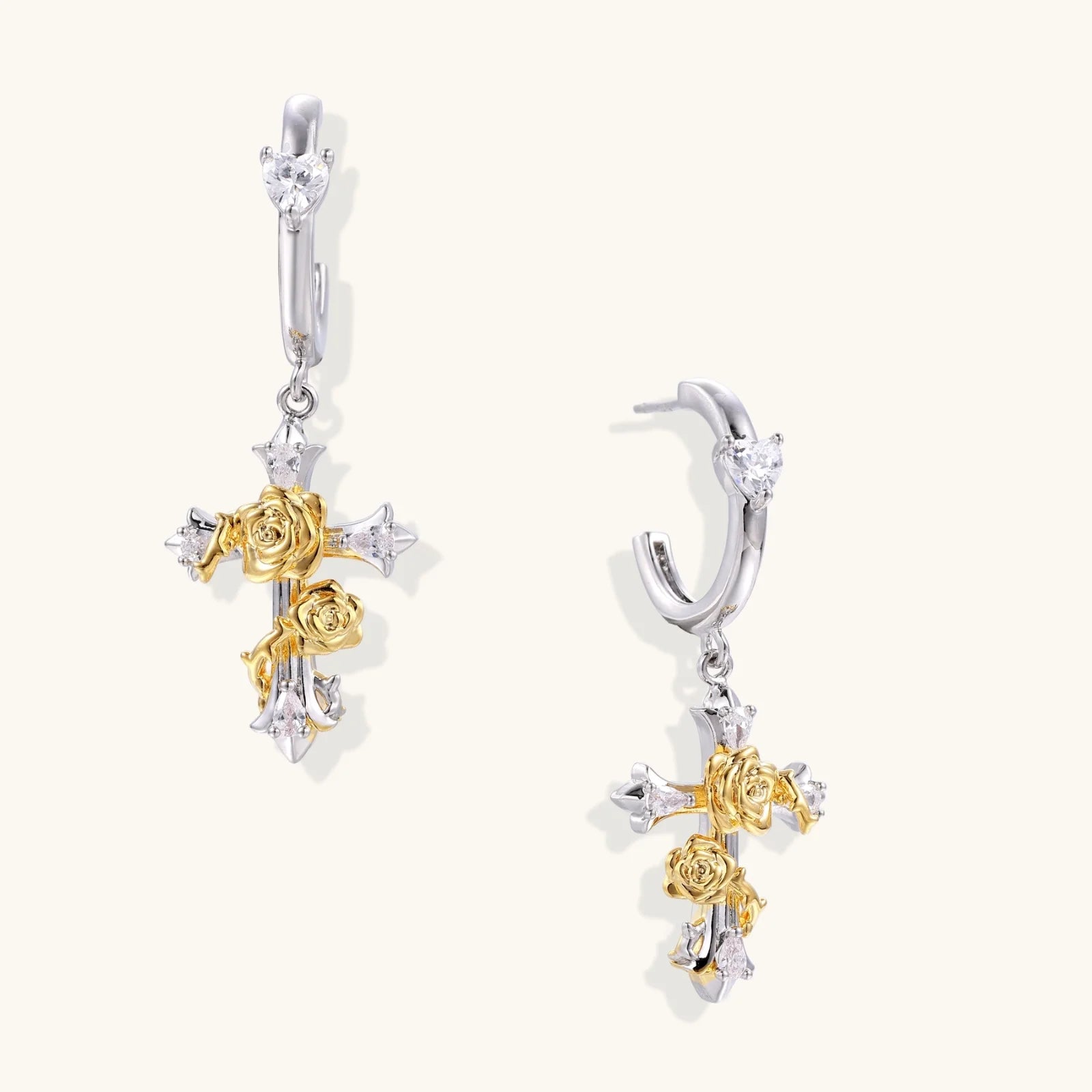 Two-tone cross earrings with gold roses and crystal stars on silver hoops, dangle drop style on white background.