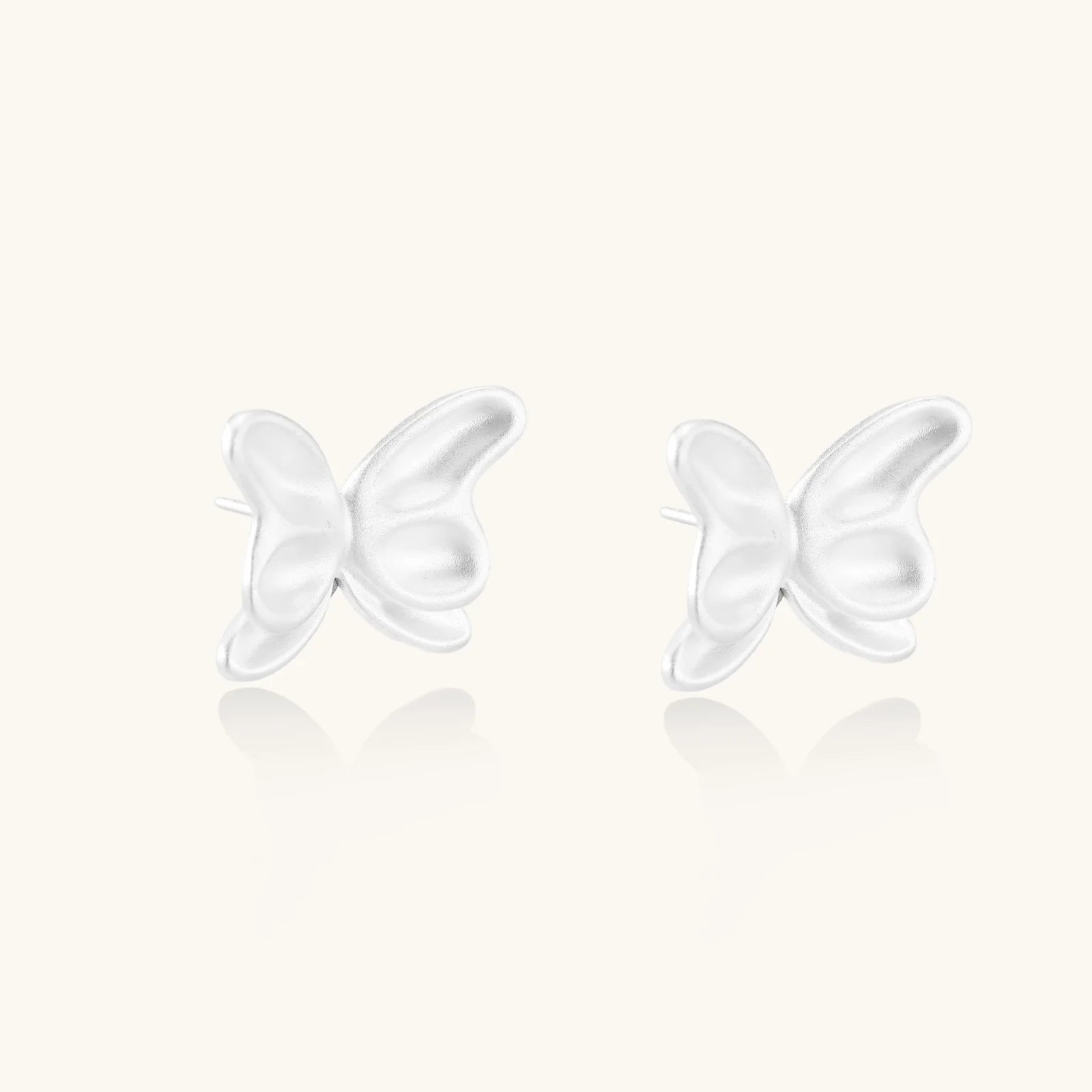 Pair of translucent butterfly-shaped stud earrings with frosted finish and dimensional wing details on white background