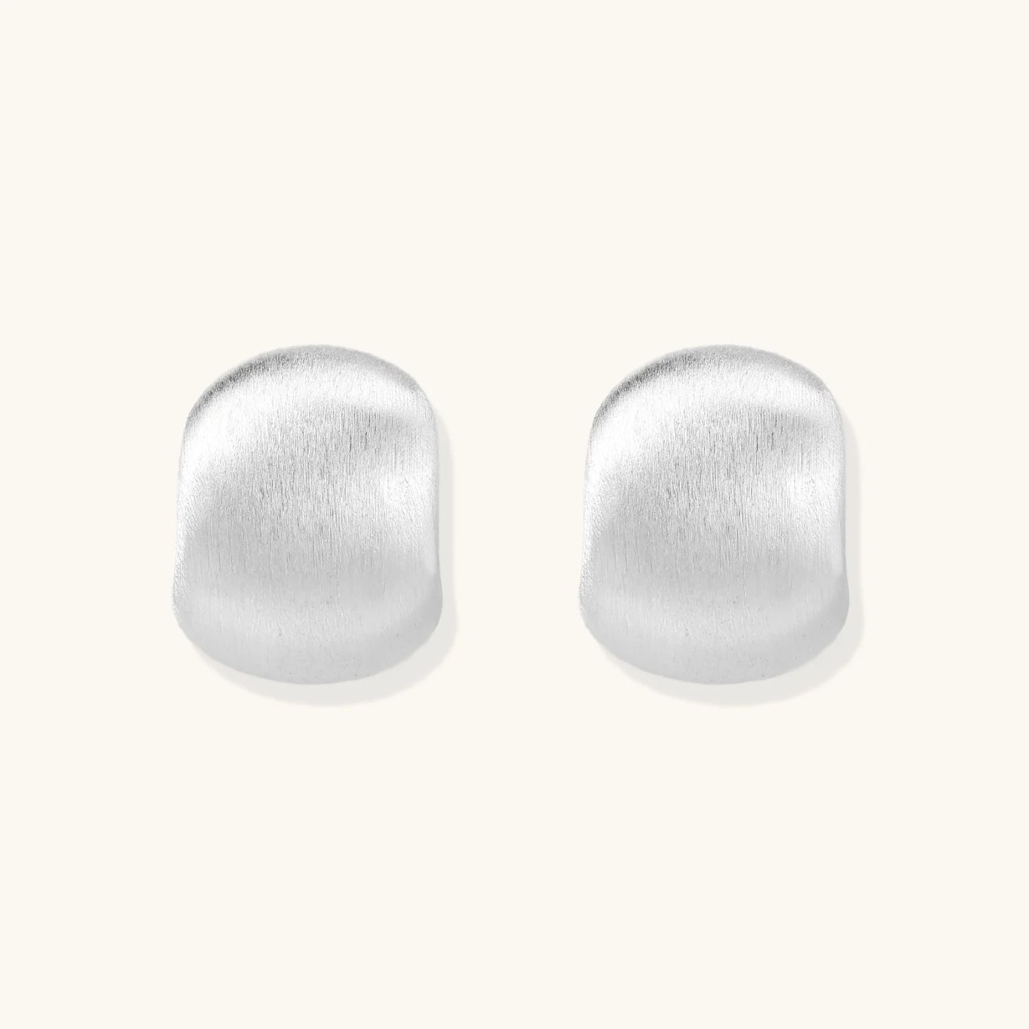 Brushed sterling silver cushion-shaped stud earrings with matte finish on white background