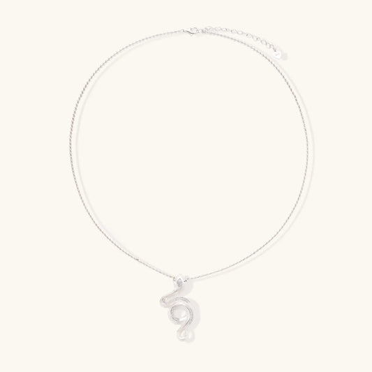 Abstract S-curve sterling silver pendant with zirconia accents on delicate chain against white background