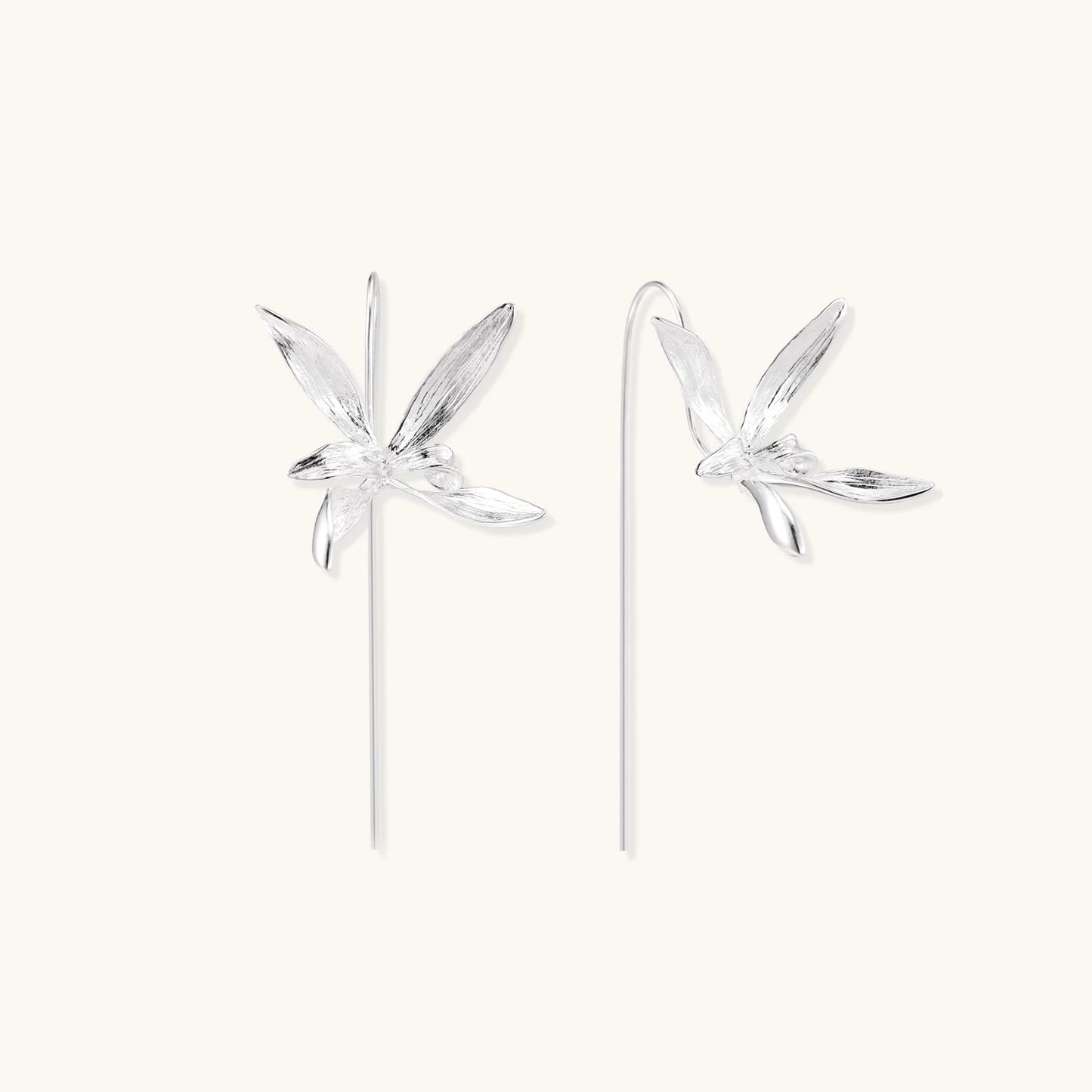 Delicate sterling silver dragonfly earrings with textured wings and curved threader hooks on white background