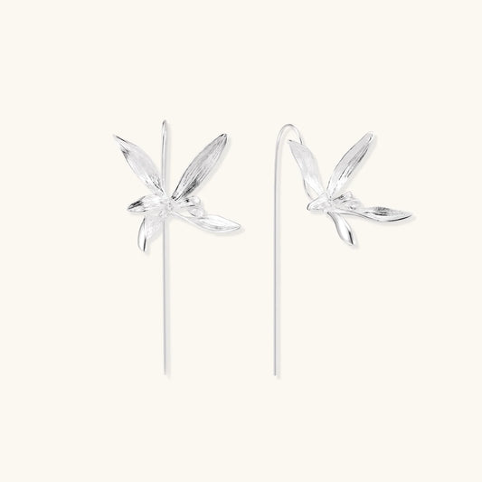 Delicate sterling silver dragonfly earrings with textured wings and curved threader hooks on white background