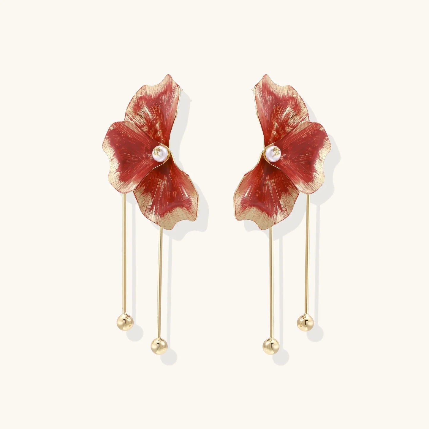 Red enamel flower earrings with gold-plated stems, central pearl, and gradient coral-to-gold petals on white background