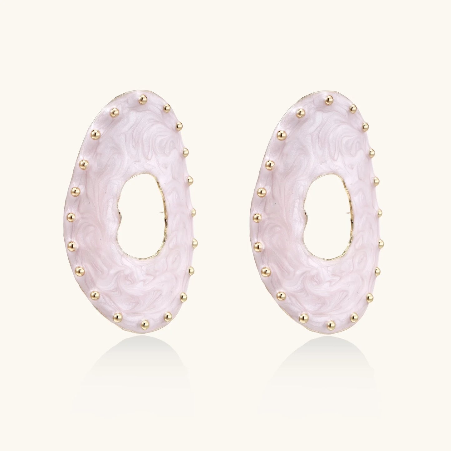 Oval lavender enamel earrings with marbled finish and gold-plated beaded border on cream background.