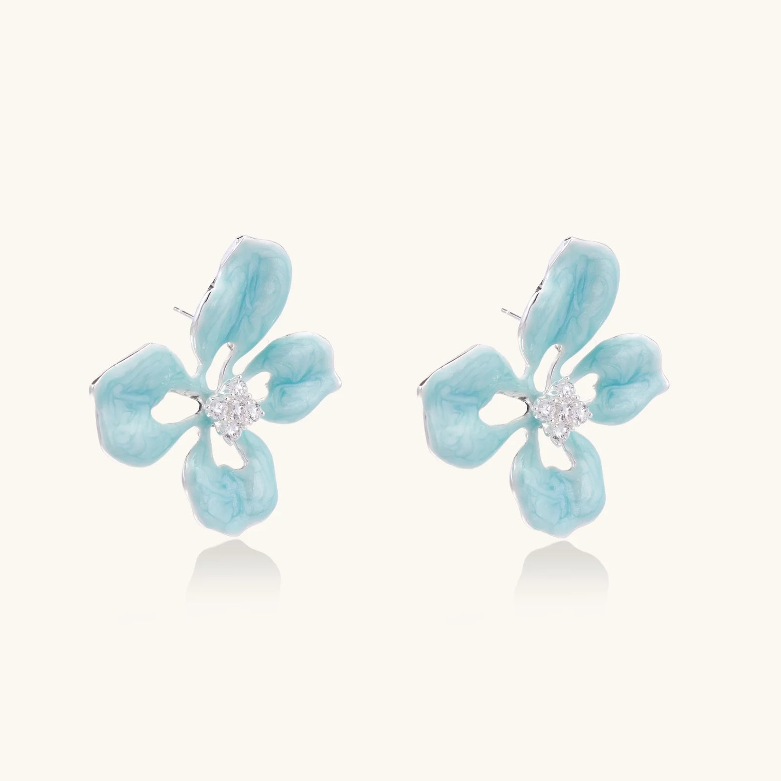 Turquoise enamel flower stud earrings with marbled finish and crystal centers on 18K gold plated brass