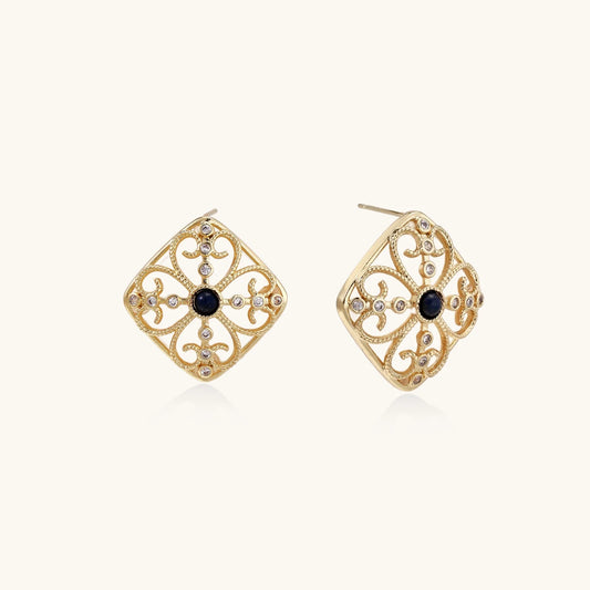 Gold filigree stud earrings with navy lapis lazuli center stone and mother-of-pearl accents in ornate quatrefoil design