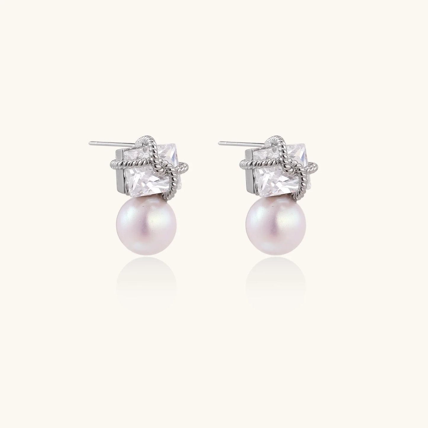 White gold stud earrings with square crystal stones in twisted frames and pink freshwater pearl drops below