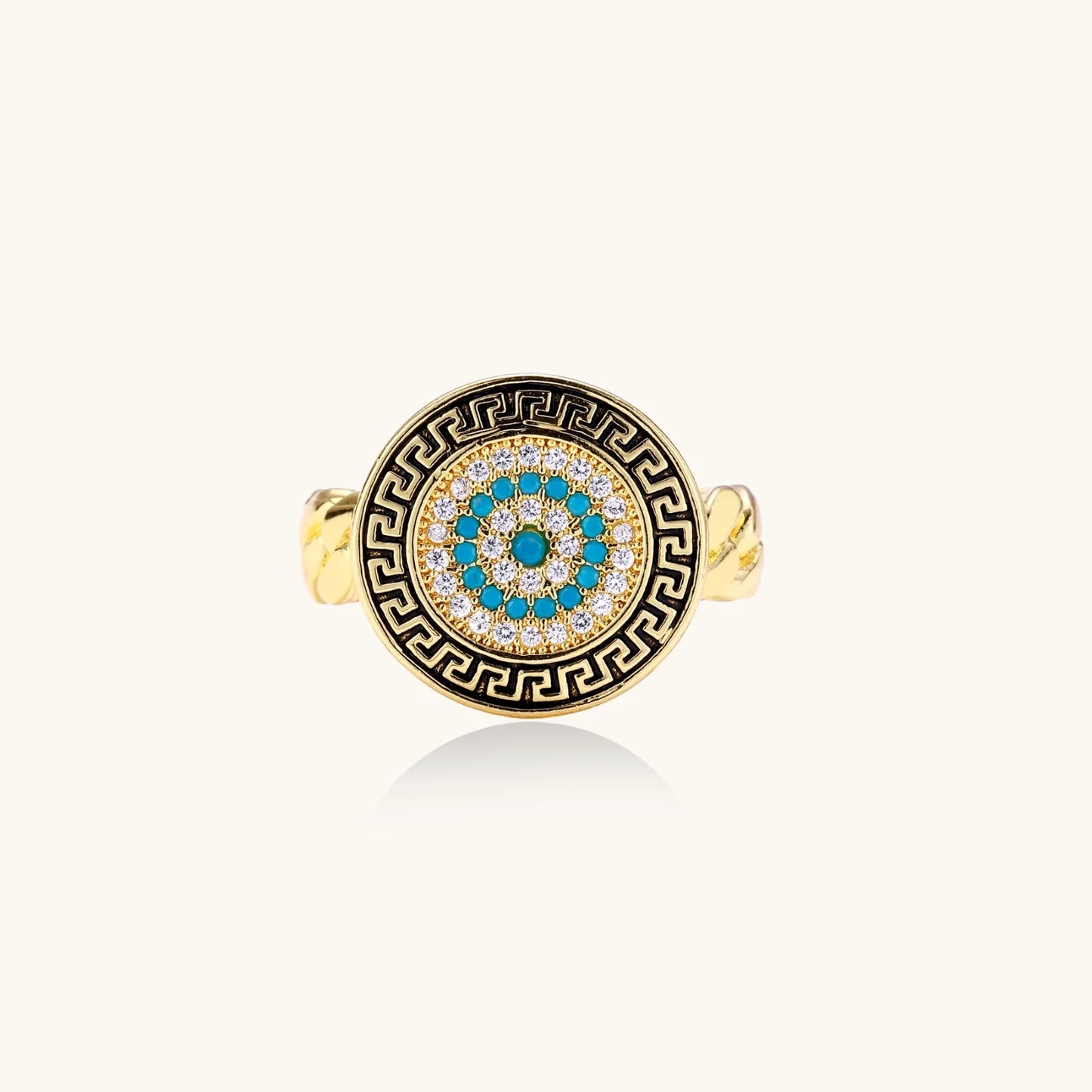 Gold chain ring with Greek key border and turquoise evil eye center on white background