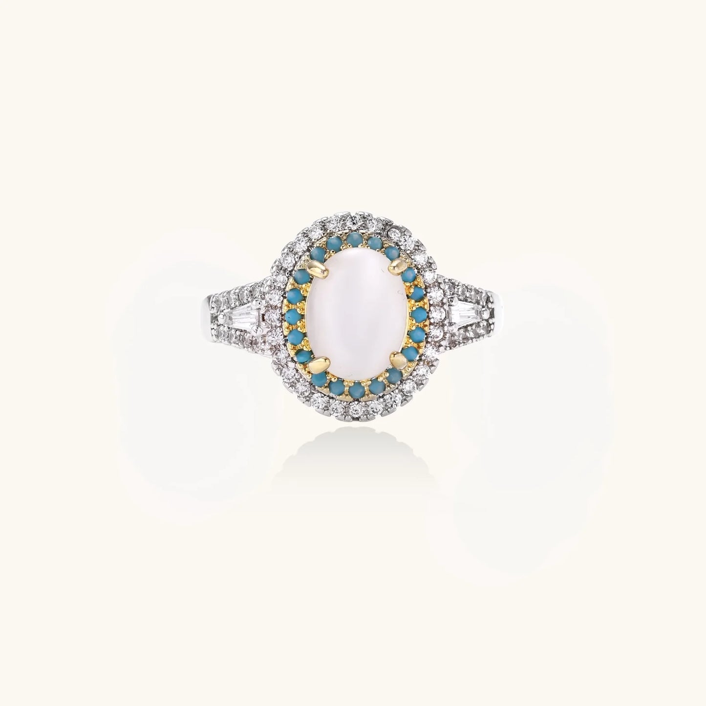 Vintage-style cocktail ring with luminous cat's eye center stone surrounded by turquoise and crystal double halo on white gold plated band
