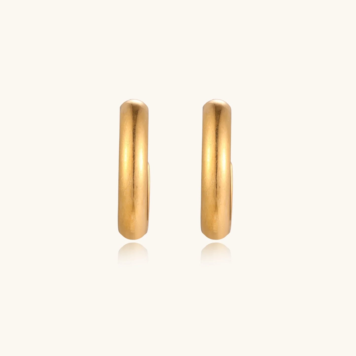 Chunky brushed gold hoop earrings in 14K plated stainless steel on cream background, front and side view.