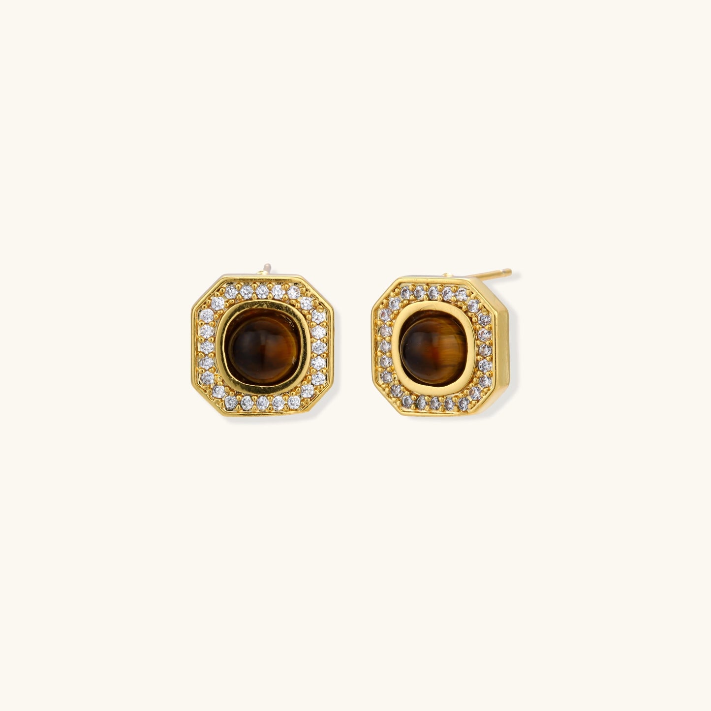 Gold-plated octagonal stud earrings with brown tiger's eye centers and cubic zirconia border on cream background.
