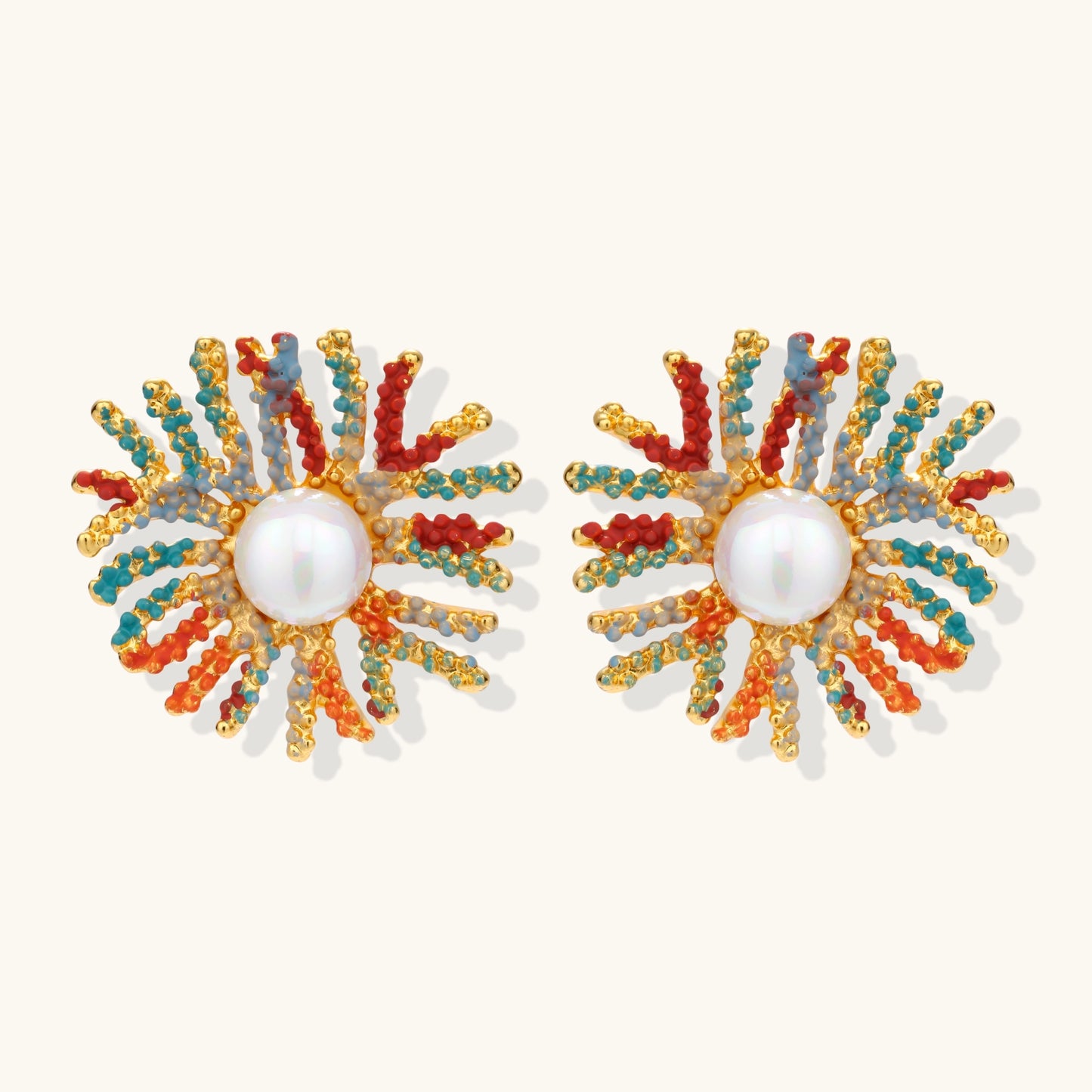 Vibrant starburst stud earrings with multicolor enamel rays and white pearl centers on gold-plated setting